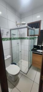 a bathroom with a toilet and a glass shower at Casa confortável para o são joão in Campina Grande +9 photos