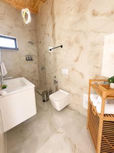 a bathroom with a sink and a toilet in it at Meis Villas in Dhërmi +46 photos