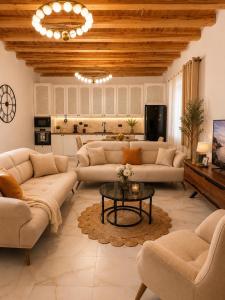 a large living room with couches and a table at Meis Villas in Dhërmi