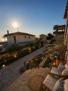 a patio with a pathway with lights and a house at Meis Villas in Dhërmi