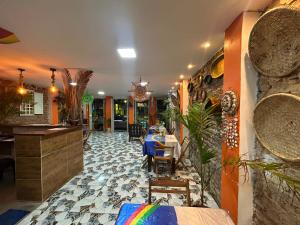 a dining room with a table in a restaurant at Pousada e Restaurante Morena Raiz in Olinda