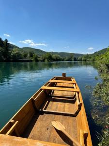 two wooden boats sitting on the water at Vila Kraljica Une in Bosanska Krupa