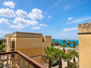 a balcony with a view of the ocean at Harba - An Escape at Fort Chambray in Għajnsielem