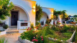 a garden in front of a house with flowers at Mihalis Studios in Karpathos +33 photos