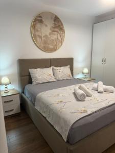a bedroom with a bed with two towels on it at Topuzi Grand House in Pogradec