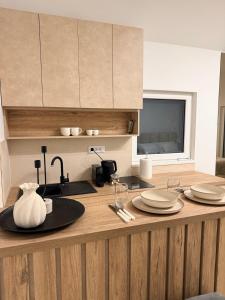 a kitchen with a counter with plates on it at Mia Bella in Sremska Kamenica +8 photos