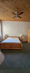 a bedroom with a bed and a ceiling fan at By Karin in Kranevo +9 photos
