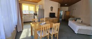 a kitchen and living room with a table and a couch at By Karin in Kranevo