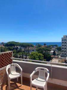 two chairs on a balcony with a view of the ocean at Il Piccolo Cristallo sul Mare in Santa Marinella