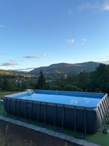 a large blue swimming pool on top of a house at Karpatski Prostory in Slavske