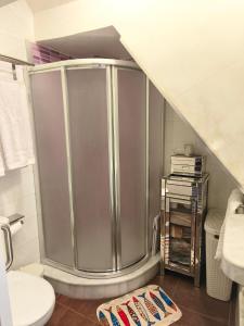 a shower in a bathroom with a sink and a toilet at La Terraza del Castillo- Playa de Rota in Rota +54 photos