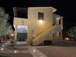 a house at night with a staircase leading up to it at Villaluciana Solanas in Solanas