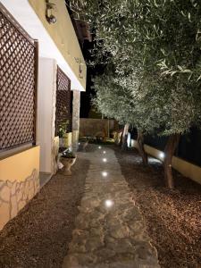 a walkway with trees on the side of a building at Villaluciana Solanas in Solanas