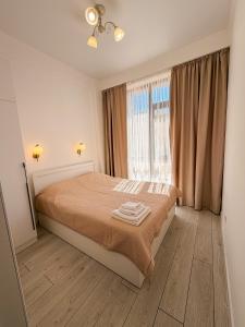a bedroom with a bed and a window at Nomad Resort Cholpon-Ata in Cholpon-Ata