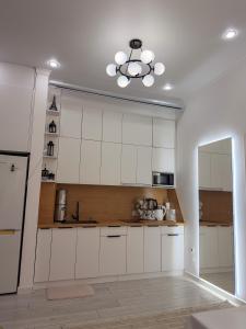 a kitchen with white cabinets and a ceiling at Nomad Resort Cholpon-Ata in Cholpon-Ata