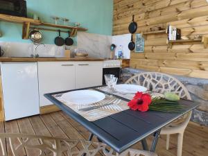 a kitchen with a table with two plates on it at Ti Colibri in Deshaies +5 photos