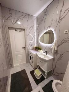 a bathroom with a sink and a mirror at Nomad Resort Cholpon-Ata in Cholpon-Ata +18 photos