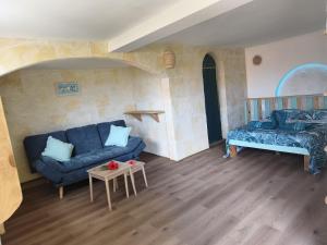 a living room with a couch and a bed at Ti Colibri in Deshaies