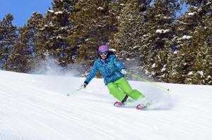 a person is skiing down a snow covered slope at The Highlands at Harbor Springs in Harbor Springs