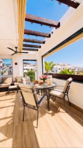 a living room with a table and chairs at La Cala Center Premium Penthouse Motorized Terrace & Sea Views in La Cala de Mijas