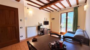 a living room with a table and a couch at Poggio Olivo in Acquaviva