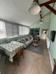 a living room with a table and a couch at Vickers in Talbenny