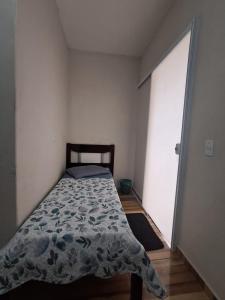 a bedroom with a bed and a large window at Suite Nomar 1 in Brotas