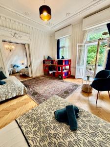 a bedroom with two beds and a room with a table at Villa Sartorius - charmant und denkmalgeschützt wohnen nahe Göttingen in Bovenden +16 photos