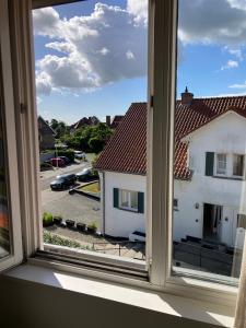 an open window with a view of a building at Christina in Nieuwpoort
