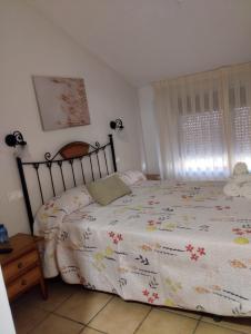 a bedroom with a bed with a comforter on it at Hostal Posada Royuela in Royuela
