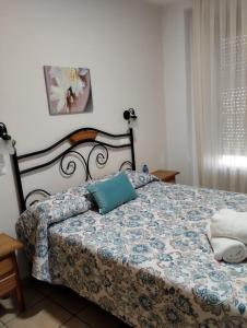 a bedroom with a bed with a blue pillow on it at Hostal Posada Royuela in Royuela