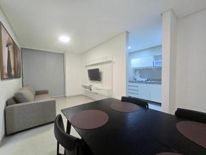 a living room with a table and a couch at Life Center in Caruaru