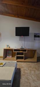 a room with a flat screen tv on a wall at Alojamiento Dina in Puerto Madryn