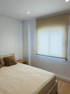 a bedroom with a bed with a large window at Palacios Centro - El Puerto in El Puerto de Santa María +6 photos