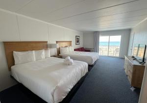 a hotel room with two beds and a balcony at Flamingo Motel in Ocean City