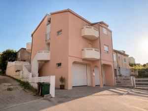 a pink building with a white garage door at Villa Apricot in Split