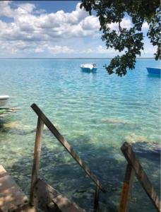 a boat in the middle of the water at Navega en velero privado Motoko en la laguna de los 7 colores en Bacalar Quintana Roo in Bacalar