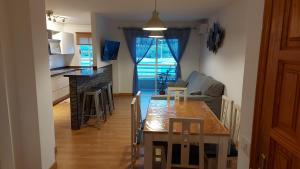 a kitchen and dining room with a table and chairs at DANAGUEST in Los Llanos de Aridane