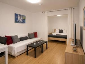 a living room with a couch and a bed at Villa Apricot in Split