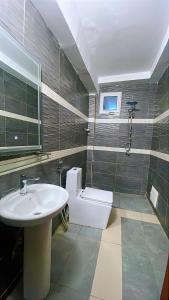a bathroom with a sink and a toilet at La case Dytobi Mermoz in Dakar +28 photos