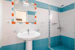 a bathroom with a sink and a mirror at The Hidden Sea Rooms in Sarandë +114 photos