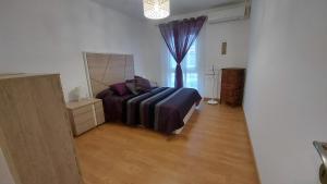 a bedroom with a bed and a large window at DANAGUEST in Los Llanos de Aridane