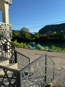 a bench on a porch with a view of a river at Vila Kraljica Une in Bosanska Krupa +5 photos