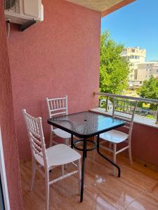 a table and chairs on a balcony with a view at Eki 2026 VIP in Donji Štoj