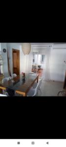 a living room with a wooden table and chairs at Apartamento Belobodia in Cáceres