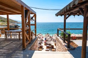 a house with a table and a view of the ocean at The Hidden Sea Rooms in Sarandë