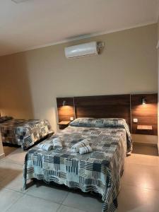 a bedroom with two beds in a room at Hotel Don Luis in Paso de los Libres