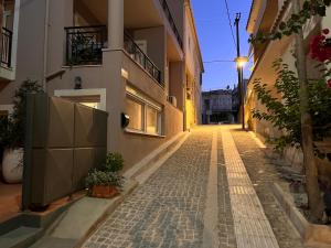 a cobblestone street in an alley at night at Central flat Argostoli in Argostoli