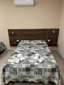 a bed with slippers on top of it in a room at Hotel Don Luis in Paso de los Libres