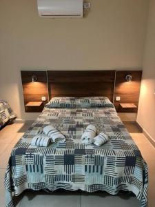 a bed with towels on it in a room at Hotel Don Luis in Paso de los Libres +34 photos